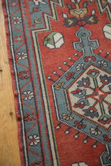Oushak rug detail: brick red field, slate gray-blue border, and even pile wear visible.