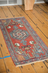 Vintage Oushak rug corner with slate gray blue border and brick red field's floral motifs.