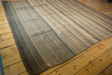 Textured horizontal bands in chocolate, coffee, and charcoal brown on the Moroccan Kilim.