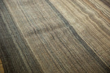 Textured close-up of vintage Moroccan Kilim with varying brown striped bands.