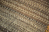 Varying brown striped bands on a hand-woven vintage Moroccan Kilim texture.