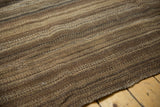 Varied thickness of horizontal brown striped bands on a vintage Moroccan Kilim.