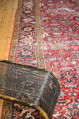 Vintage Heriz rug's red field with geometric floral designs and distinct patterned border.
