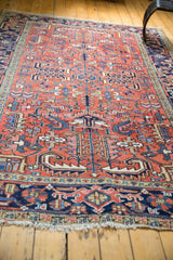 Worn fringe and navy blue border of a vintage Heriz rug with rectilinear motifs.