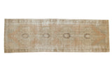 Distressed vintage Oushak runner with geometric medallions in pale apricot and ivory, 2'10