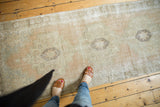 Distressed vintage Oushak runner, faded peach, ivory, brown geometric pattern, mostly even wear.