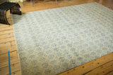 Vintage distressed Oushak carpet with ivory field, allover blue floral vinery lattice pattern.
