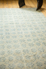 Distressed texture and faded teal floral motifs with delicate vinery on vintage Oushak rug.