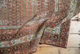 Distressed Mir Serbend rug's madder red boteh pattern and slate blue borders with even wear.