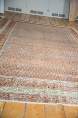 Detailed floral border and distressed Mir boteh field in red, ivory, and slate blue tones.