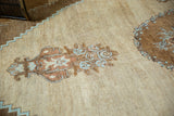 Vintage Oushak rug detail: abrash, potted plant motif, stepped border in pale rust, powder blue.