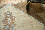 Vintage Oushak carpet detail: unique potted plant motif and stepped border in sand, blue, and madder.