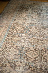 Vintage Sivas carpet, faded floral palmette pattern in charcoal, dusty rose, and teal.