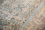Distressed Sivas carpet detail showing faded palmette and vinery motifs with a teal border.
