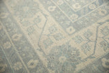 Pakistani Khotan rug showing powder blue border with antique ivory floral motifs.