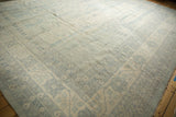 Corner of a Pakistani Khotan carpet showing powder blue Samarkand style patterns and ivory field.