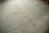 Corner detail of the Khotan style carpet, showcasing pale denim blue and ivory geometric border patterns.