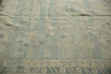 Low pile Pakistani Khotan rug with pale denim and ivory border pattern.