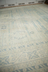 Pale denim blue geometric border on vintage Khotan style carpet with antique ivory field.