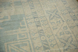 Powder blue geometric and stylized motifs on an antique ivory Khotan rug.