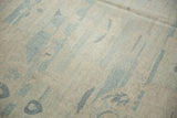 Visible hand knotted low pile texture with powder blue and antique ivory patterns.
