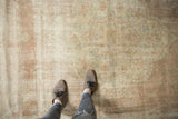 Distressed pile of vintage Sparta carpet, showing faded dusty rose motifs and foundation.