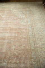 Distressed Sparta carpet: dusty rose field, traditional antique ivory border, wear to knot heads.