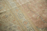 Textured vintage distressed Sparta rug showing dusty rose field and antique ivory border.
