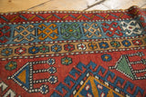 The low, even pile and complex geometric border of a hand-knotted Persian Karaja rug.