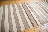 Repeating chocolate brown and ivory stripes showcasing varied handwoven textures in the Moroccan Kilim.