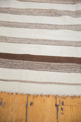 Vintage Moroccan Kilim runner's hand-woven brown and ivory striped bands with fringed edge.