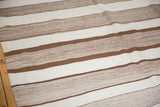 Varied natural chocolate brown and ivory striped texture on a Moroccan Kilim runner.