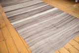 Vintage Moroccan Kilim runner's texture with horizontal striations, pale coffee, and ivory abrashes.