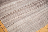 Vintage Moroccan Kilim rug showing horizontal striations and natural abrashes in brown and ivory.