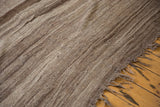 Textured undyed brown abrashes and fringed end of the vintage Moroccan Kilim runner.