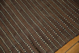Hand woven Moroccan Kilim runner showcasing natural brown and ivory dashed line pattern.