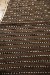 Hand-woven texture of natural undyed wool with chocolate and ivory dashed stripes.