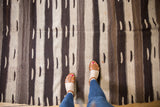 Hand woven Moroccan Kilim with natural ivory and brown banded stripes and inset dashes.