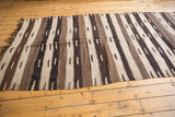 Natural ivory and dark brown striped Kilim flat-weave with distinct inset dashes.