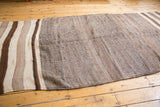 Natural ivory and brown hand woven texture with banded striations on vintage Kilim runner.