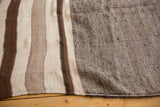Alternating natural ivory and chocolate brown stripes with fine striations.