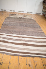 Vintage Moroccan Kilim runner with thick banded stripes in natural ivory and browns.