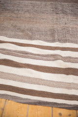 Textured detail of vintage Moroccan Kilim runner with alternating natural ivory and brown bands.