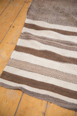 Varied banded texture of a vintage Moroccan Kilim runner in ivory and natural brown.