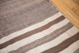 Hand-woven ivory and chocolate brown stripes on a vintage Moroccan Kilim runner.