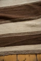 Moroccan Kilim rug close-up: coffee brown and ivory striated bands with geometric detailing.