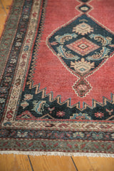 Madder root red vintage Karabagh runner with navy blue geometric pattern, ornate border, and fringe.
