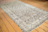 Full perspective view of a vintage Hamadan runner with a neutral allover Herati design.