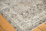 Close-up of the vintage Hamadan rug corner, showing the low pile and neutral-toned Herati border.