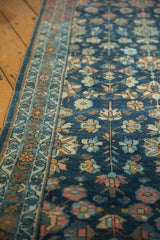Intricate geometric border and blossoming floral field of a hand-knotted Lilihan rug.